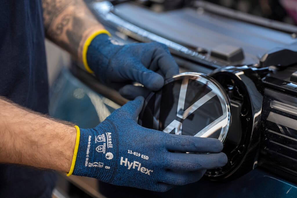 Simbolo da Volkswagen sendo instalado em um veículo